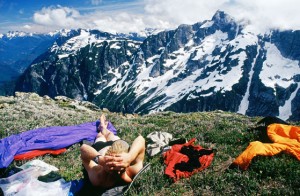 A hiker enjoys the view of the mountain and valley beyond