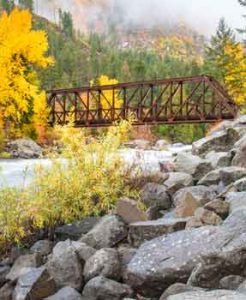 A bridge crosses over a river in Chelan County in Autumn