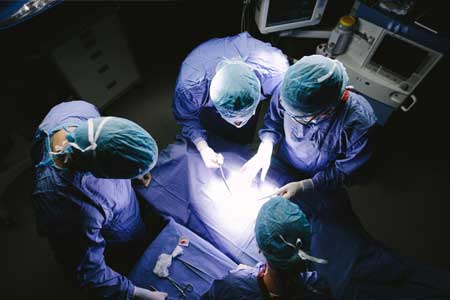 Surgeons begin a surgical procedure in a hospital.