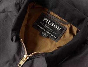 The collar of a Filson brand jacket, showing the company's label.