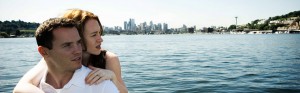 A couple looks back at the Seattle skyline from the north shores of Lake Union