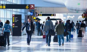 Passengers walk through Sea-Tac International's airport concourse