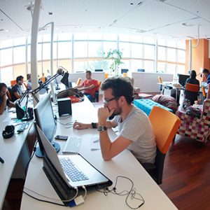 Software developers on deadline in a spacious open office