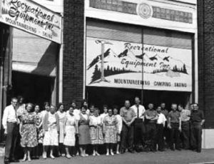 Employees pose in front of one of REI's original stores.
