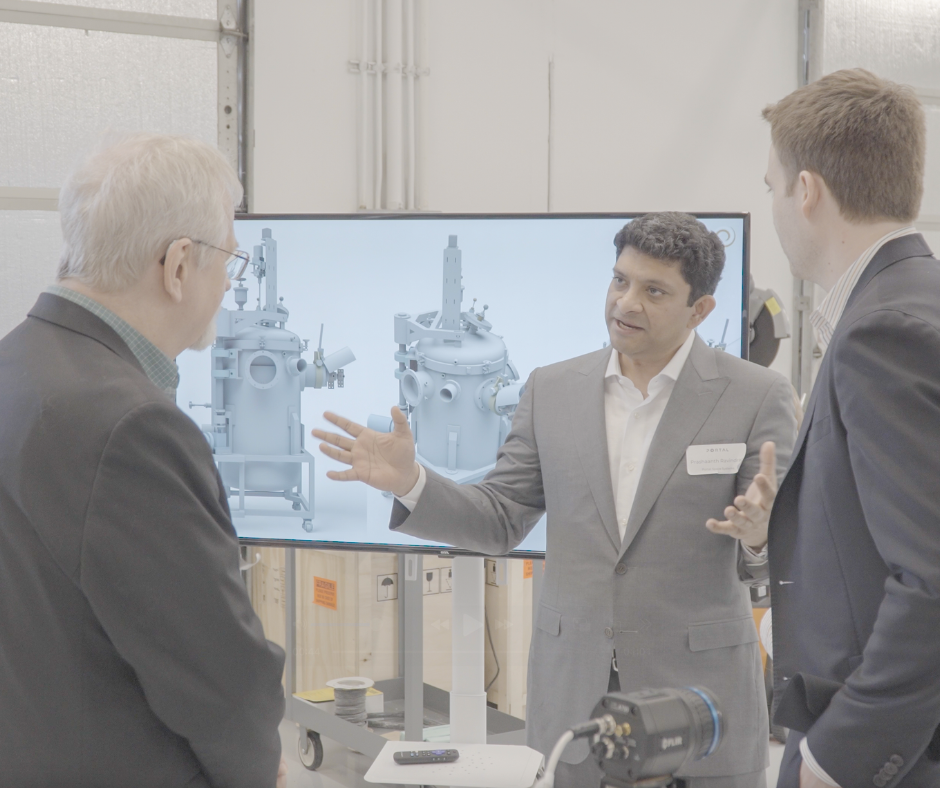 Portal Space Systems VP of Engineering Prashaanth Ravindran, talks with visitors.